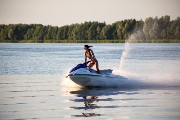 a girl riding a jet ski in a body of water